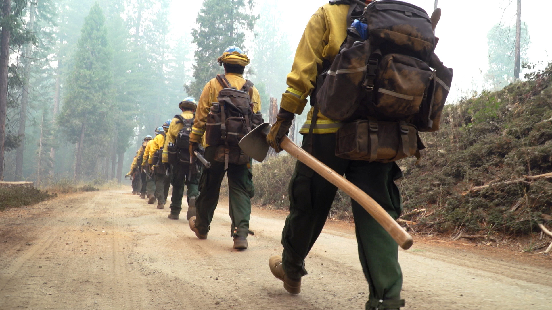 Project-of-the-Year-Emergency-Response Corpsmembers with the Placer 1 fire crew cut fire line with hand tools as flames from the Dixie Fire approach in 2021.