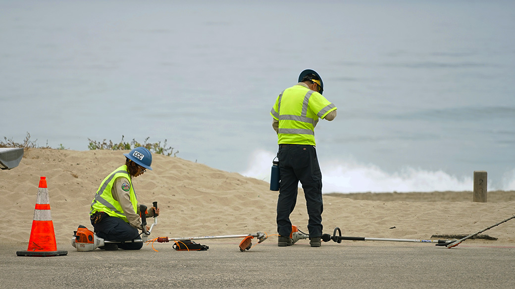 Corpsmembers on a beach, working on a project.