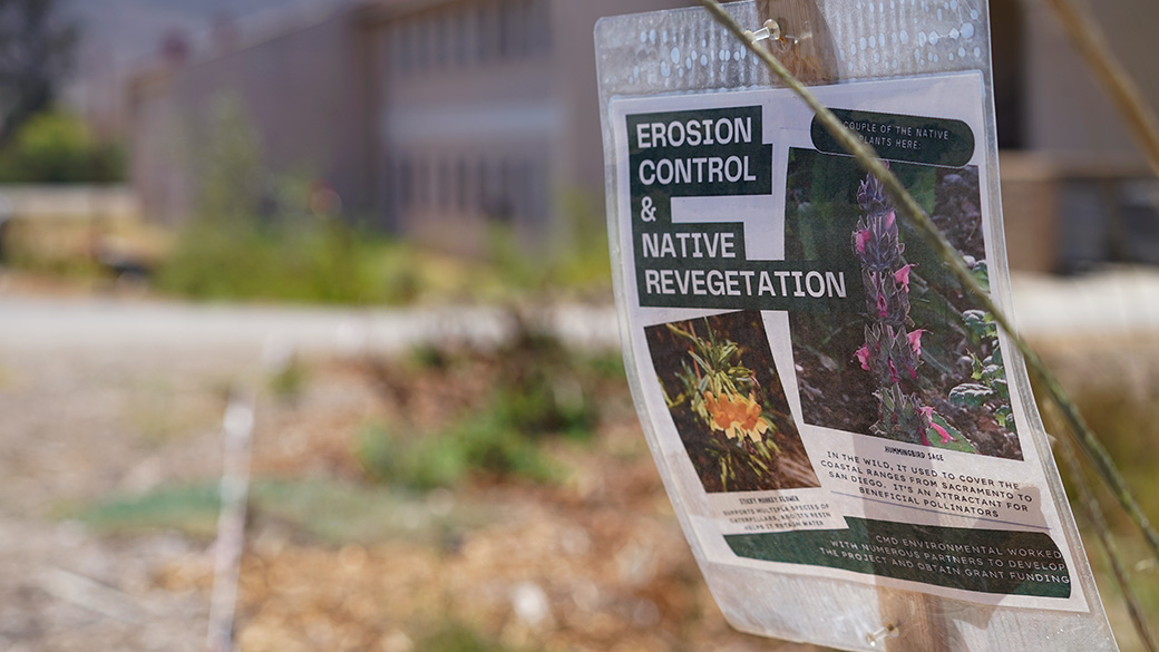 photo of sign in the foreground that reads, erosion control and native revegetation