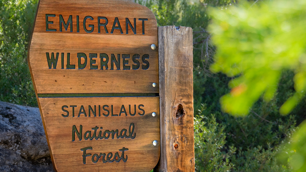 A wooden sign marks the entrance into Emigrant Wilderness, part of the Stanislaus National Forest.