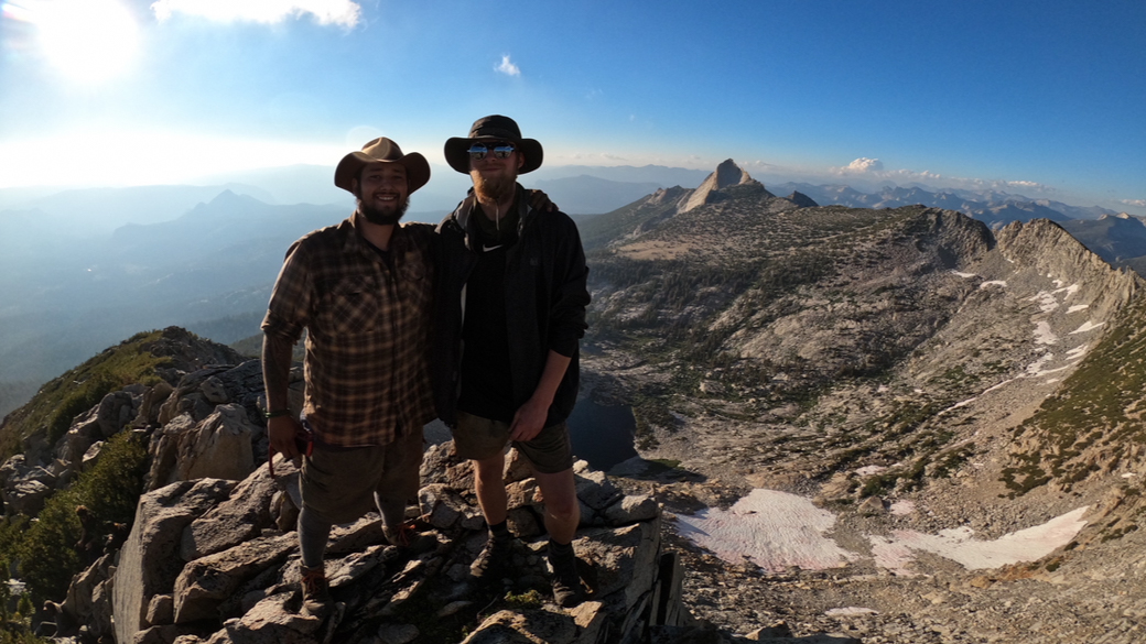 Corpsmember Steven Banuelos poses at the top of a peak in the Yosemite Backcountry. 